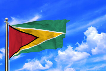 Vibrant Flag of Guyana Waving Against a Clear Blue Sky