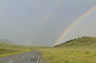 Country road and double rainbow