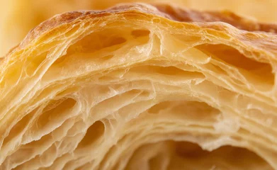 Extreme close-up of flaky pastry layers showcasing its golden, crisp, and delicate texture.