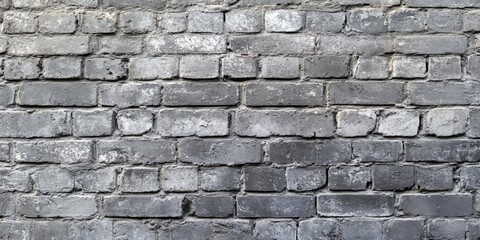 Obraz premium Textured old grey brick wall background showcasing the rustic charm and character of an aged grey brick wall, perfect for adding an authentic touch to various design projects.