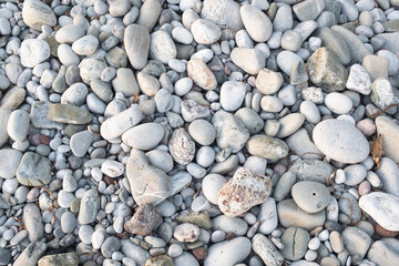 Sea pebbles on the beach, close-up. Pebble background for publication, poster, calendar, post, screensaver, wallpaper, postcard, banner, cover, website. High quality photo