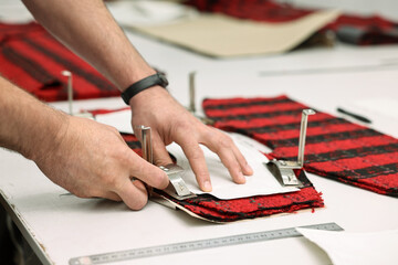 Man working at white table in professional workshop, closeup