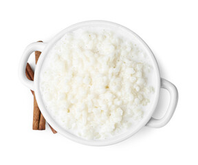Delicious rice pudding with cinnamon sticks isolated on white