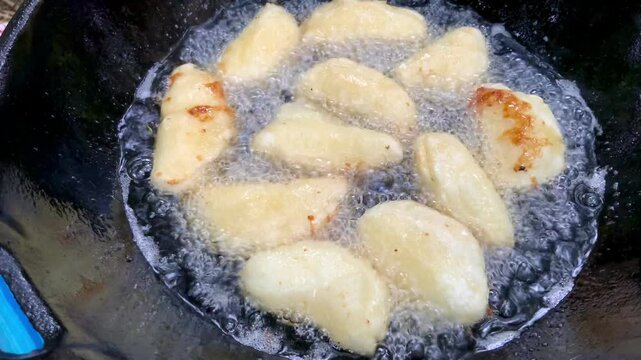 A traditional Indonesian snack called &lsquo;Entho Cotot&rsquo; made from tree tubers filled with granulated sugar, fried to golden perfection in a pan. A unique and delicious treat with a crispy exterior and swe