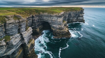 Dramatic Coastal Cliffs with Turbulent Waves and Overcast Sky