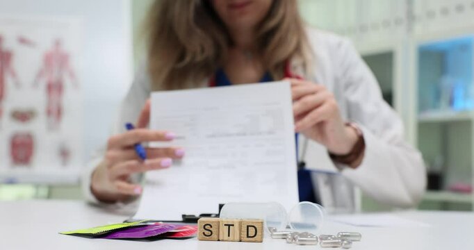 In a clinic, a dedicated healthcare worker is reviewing medical documents and STD test results for accuracy