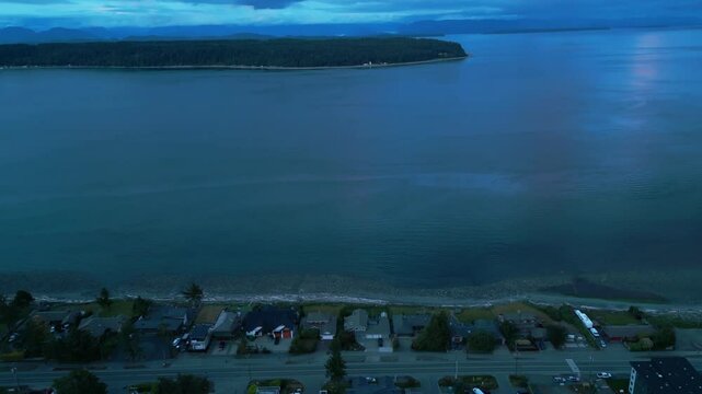 aerial shot revealing discovery passage and quadra island from campbell river just after sunset at the blue hour, vancouver island, british columbia, canada