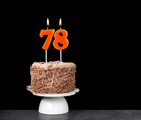 Birthday cake with number 78 candle - Anniversary card on a black background