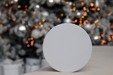 New Year interior. White gift box on bokeh background. Close-up. Copyspace