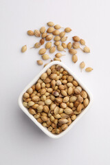Indian spice Coriander seeds in a small ceramic bowl