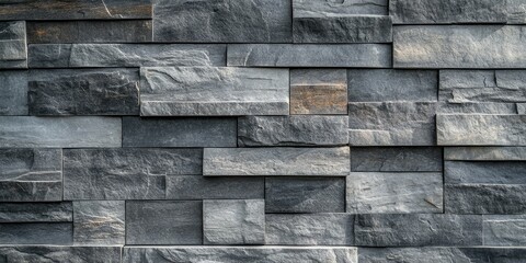 Gray stone wall featuring a unique texture, offering a captivating background. This gray stone wall provides an intriguing visual appeal with its distinctive texture, ideal for various creative