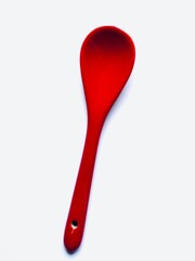 Red ceramic spoon on white background