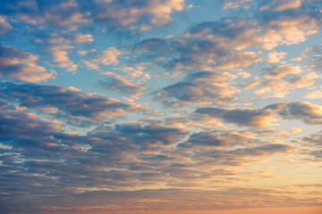 Fototapeta premium Colorful fluffy clouds and sunrise shines on blue sky