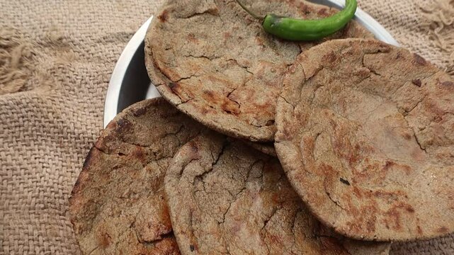 Indian traditional winter food bajre ki roti served with green chilli 