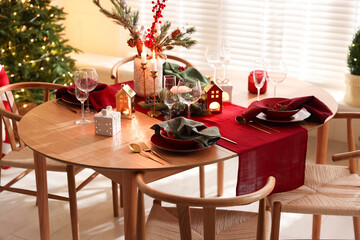 Christmas table setting with stylish dishware and festive decor indoors