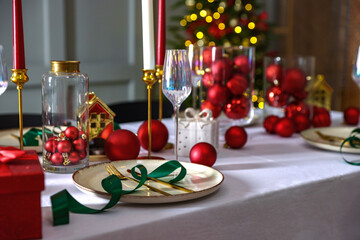 Christmas place setting with festive decor on table in room