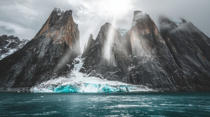 Dramatic mountain landscape with glacier and sunlight rays reflecting