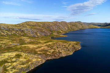 Blue sky over a river in the tundra.