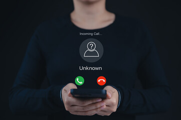 Fraud and Phishing Concept with Unknown Caller Alert. A phone displaying an incoming call from an...