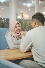 Arm wrestling challenge between a young Indian asian couple - having fun in the gym