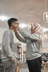Portait of happy Asian muslim couple smiling, husband and wife hugging and kissing full of love, family concept