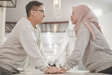 Obraz premium Muslim couple, hands together for support and empathy with care and love, solidarity and trust in relationship. Help, comfort and bonding with commitment in Islam, people in marriage with respect