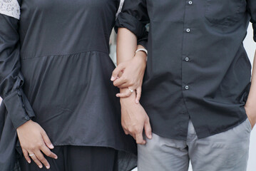 Happy stylish romantic couple embracing, looking at camera standing together at new home. Portrait...