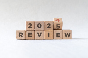 Flipping of 2024 to 2025 on wooden blocks. 2024 business and customer review for business strategic...