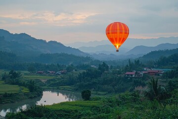 Naklejka premium Hot air balloon flying over the mountains in the sunset time.