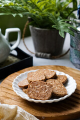 A close-up view of delicious chocolate almond cookies neatly arranged on a white plate.  A popular cookies in Malaysia during Eid Mubarak (Hari Raya)