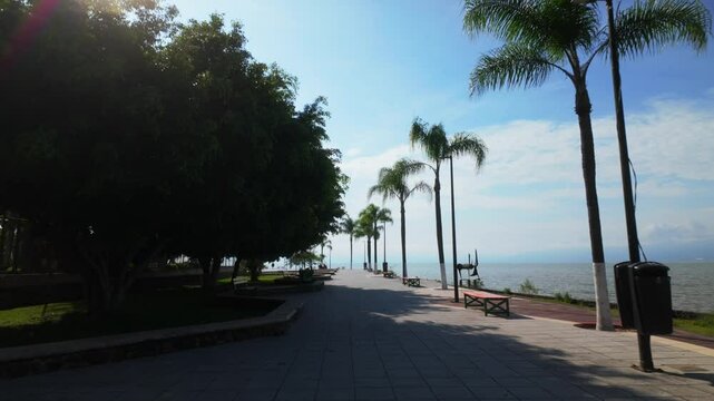 Lakeside promenade in Ajijic with palm trees and a serene waterfront view