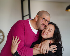 Generated two friends, a man and a woman, hug each other very emotionally at a party inside a house