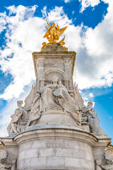 Low-angle shot of the famous Victoria Memorial, a monument to Queen Victoria, located at the end of The Mall in London by sculptor Sir Thomas Brock. At the top stands a gilded bronze Winged Victory.