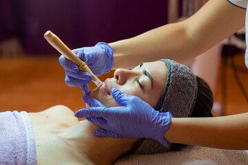 Beautiful woman in spa salon getting face treatment