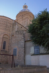 stone old church with a dome, towers, and different windows on the walls