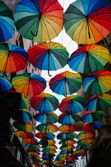 Multicolored umbrellas suspended mid air, transforming a pedestrian walkway into a vibrant spectacle of color and design in Istanbul, Turkey