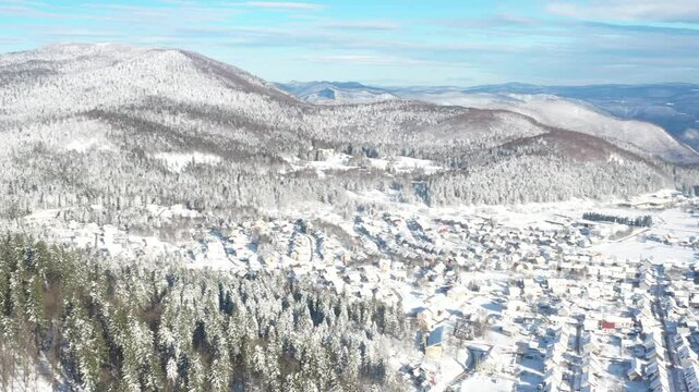 Drone aerial view of the town of Delnice in Gorski kotar in winter under snow, Croatia