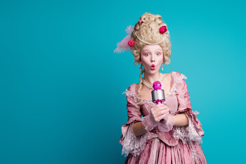 Photo of gorgeous medieval lady victorian era singer wear pompous ruch gown hold mic isolated on blue color background