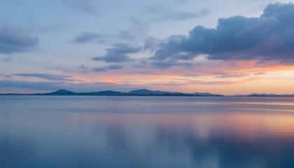 Obraz premium a view of a body of water with a mountain in the distance