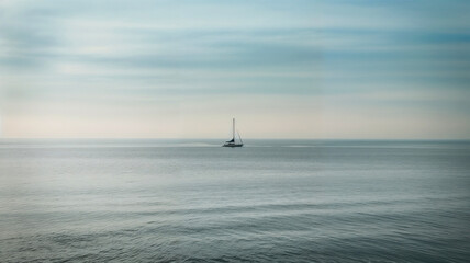 Minimalist sailboat on calm ocean under soft sky with copy space