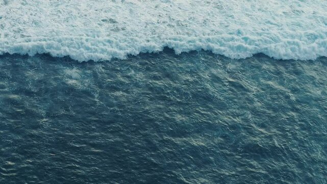 Endless ocean waves top view waves moving endless and ever-changing nature of sea. Tidal pulse high-angle view of ocean waves revealing pulsating energy flow and crash raw power motion of ocean.