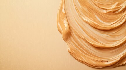 Hydration helps reduce aging skin and supports anti-aging. A smooth, creamy texture of a beige substance, likely a cosmetic or food product, elegantly swirled against a simple background.