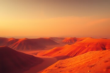 Naklejka premium Desert Sunrise: A panoramic view of rolling red sand dunes bathed in the warm glow of a vibrant sunrise. The dramatic landscape evokes a sense of wonder and tranquility.