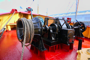 Tugboat winch and mooring ropes situated at the prow end of the ship
