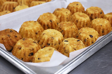 Fresh baked muffins with raisins in the pastry shop. Confectionery, New Year desserts