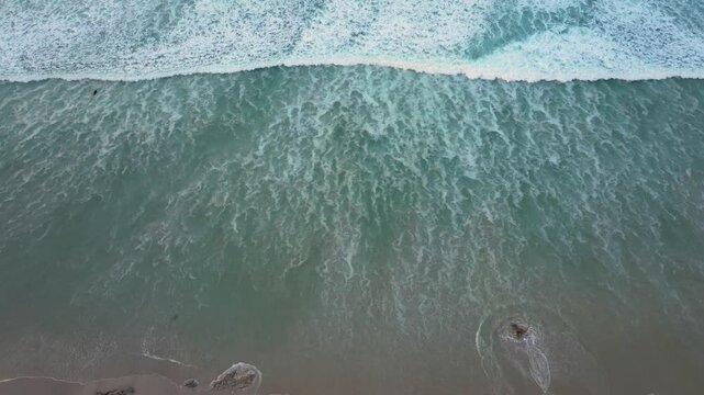 Playa de Caion Ocean Surfing Beach Waves Crashing On Shore In A Coru&ntilde;a, Spain. aerial top-down, slow motion shot