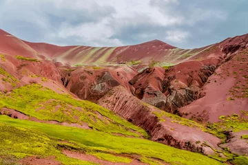 Red valley mountains near to Rainbow mountain Vinicunca in Peru. One of the natural wonders sightseeing in South America. Peruvian red soil and rock formations near Cusco in the Andes