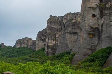 Meteora monasteries on the tops of rocks in the mountains. Interesting shaped rock formations in Greece. Beautiful mountain landscape.