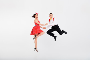 Full body portrait of two retro dancing partners hold arms jumping isolated on white color background