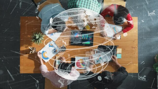 Top down aerial view of business team discussing about global networking system while looking at document with hologram of communication technology or telecommunication. Creative startup. Convocation.